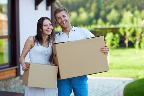 Professional movers carrying furniture from a flat in Kentishtown